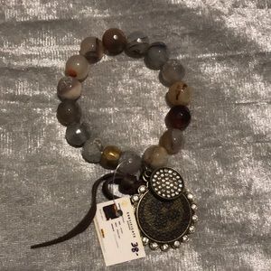 Cute never worn bracelet with charm. Still has tag on it. Warm toned